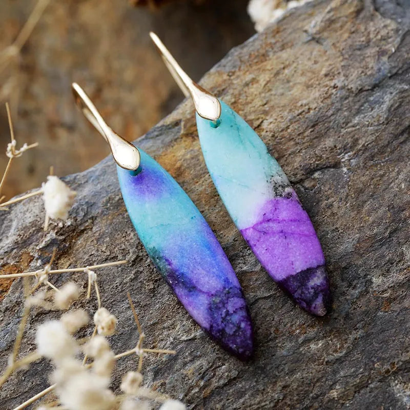 Verdant Stone Teardrop Dangle Earrings in blue/purple/gold feature marbled purple and teal stones with gold hooks.