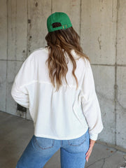 White textured boxy utility shirt jacket with button detail, shown from the back.