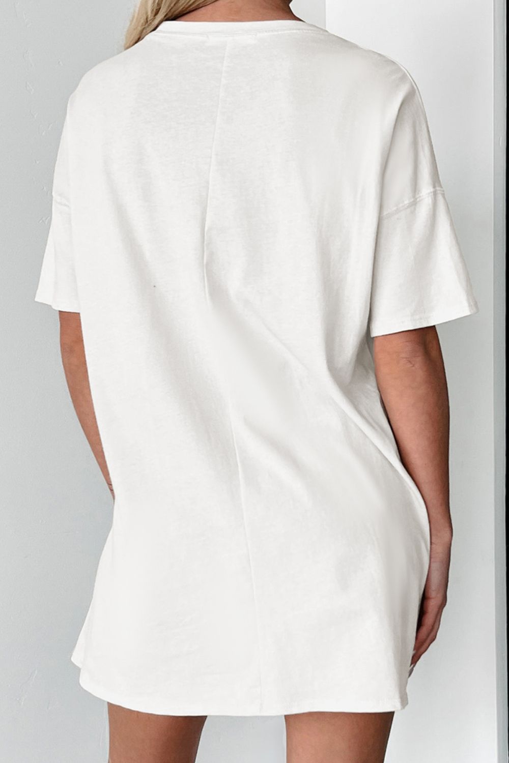 White cotton blend tee dress with short sleeves and a relaxed fit.