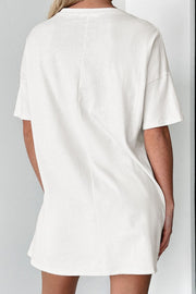 White cotton blend tee dress with short sleeves and a relaxed fit.