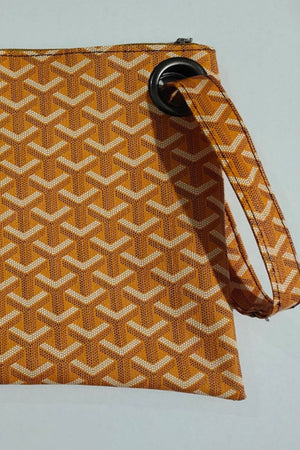 Tangerine plaid print wristlet clutch bag with black grommet detail and strap.