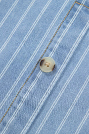 Denim mini dress with vertical white pinstripes and a light brown button detail.