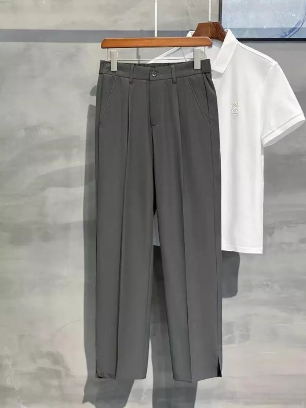 Men's dark gray sweatpants with elevated seam detail and side slits.
