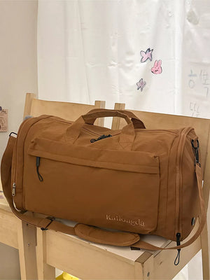 Brown Oxford cloth travel bag with detachable strap and front zip pocket
