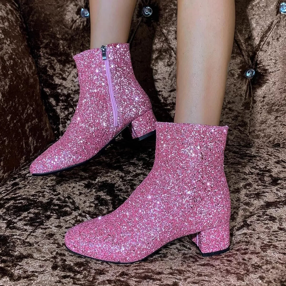 Pink sequin ankle boots with block heel and side zipper detail.