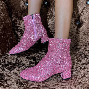 Pink sequin ankle boots with block heel and side zipper detail.