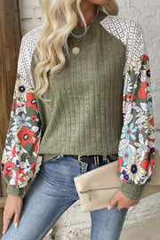 Moss green ribbed blouse with floral print sleeves and white lace yoke.