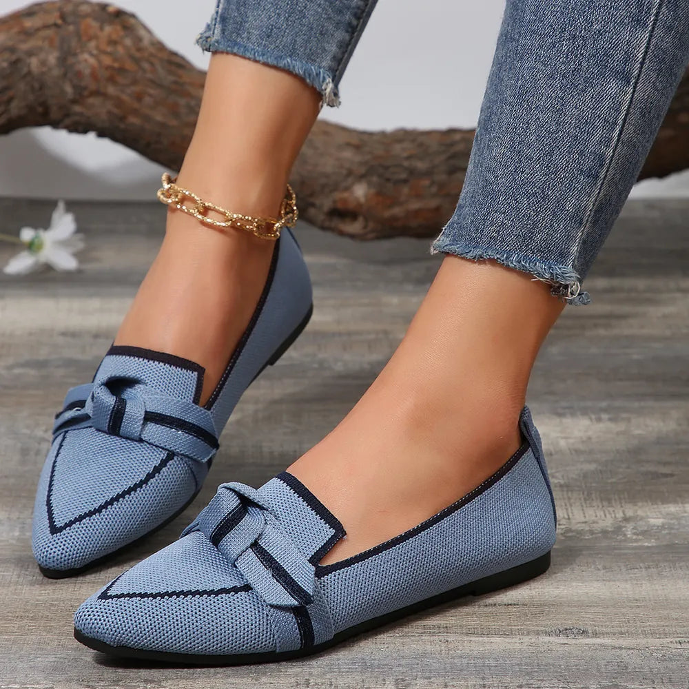 Light blue mesh pointe slip-on flats with a bow detail and navy trim.