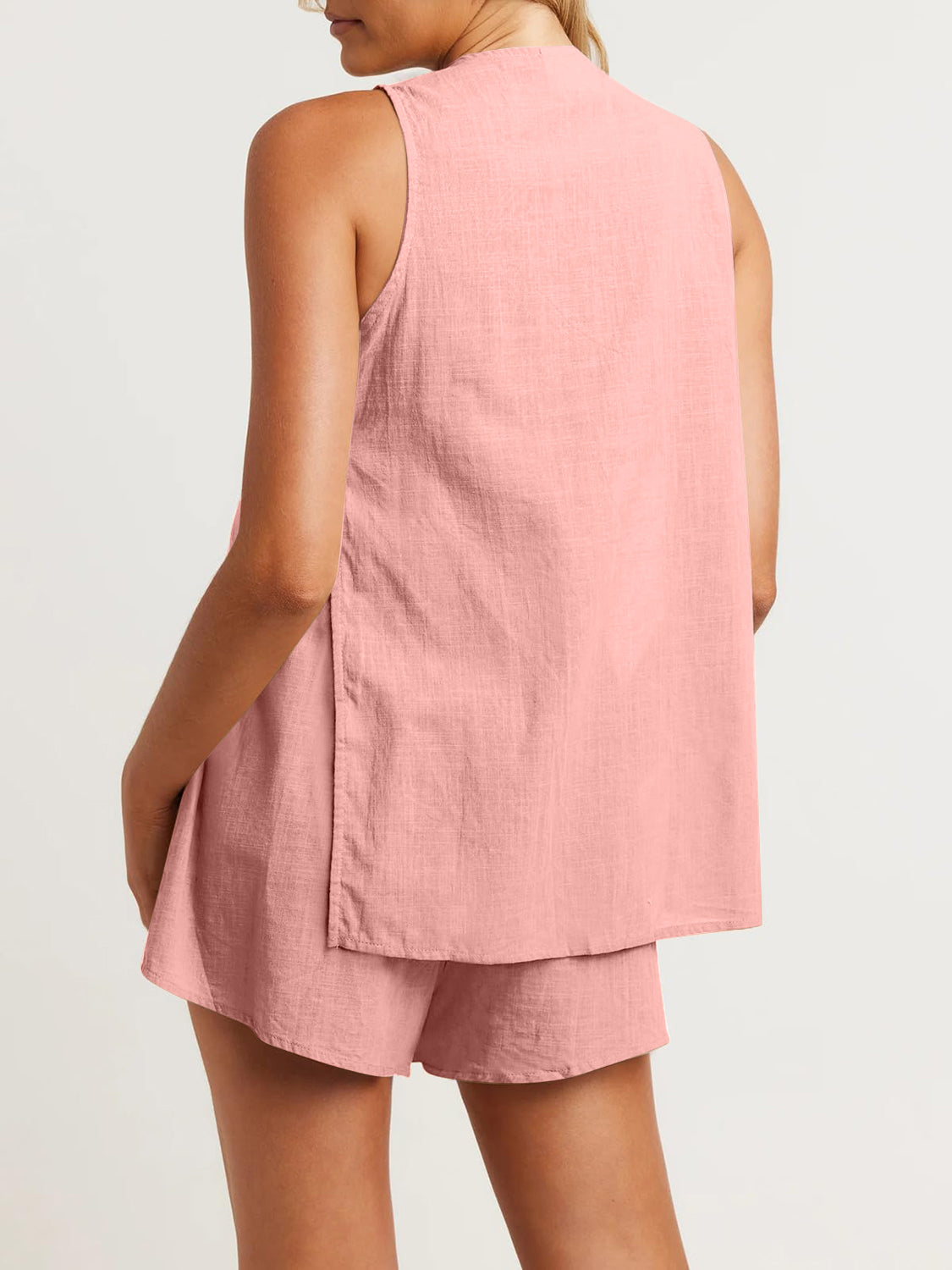 Cut-out back linen co-ord set in Burnt Coral, sleeveless top with side slits and matching shorts.