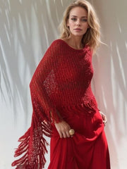 Open-knit red acrylic boat neck poncho with fringe trim detail.