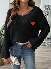 Black slouchy boatneck knit sweater with embroidered red heart detail