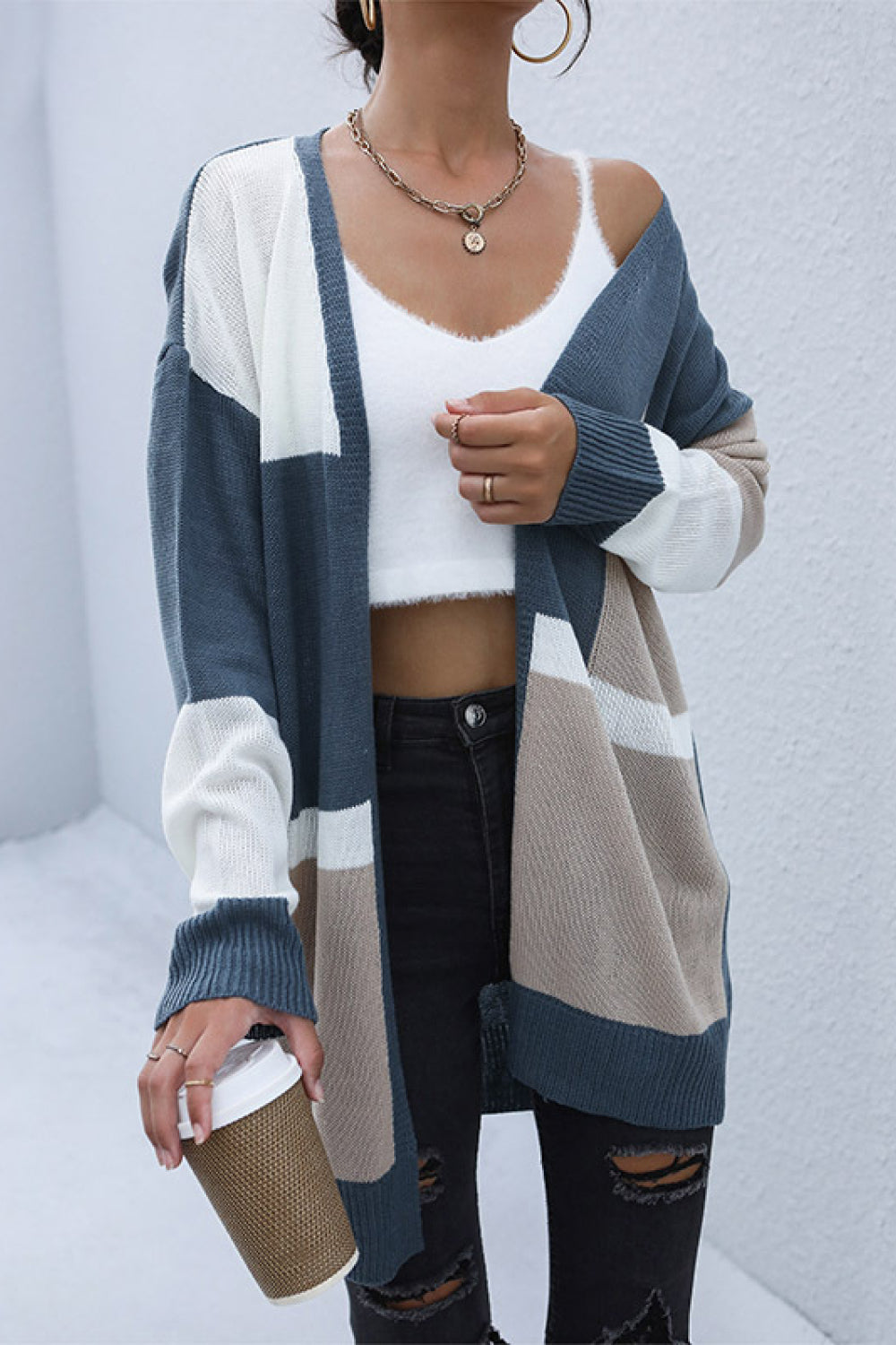 Geometric panel knit cardigan in blue, khaki, and white with a relaxed fit.
