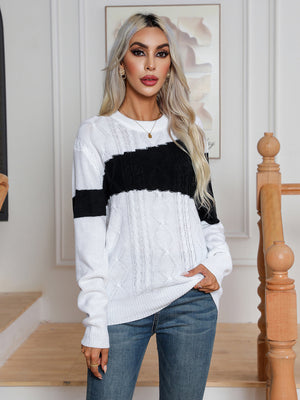 Colorblock cable knit crewneck sweater in white with black stripe detail and acrylic material.