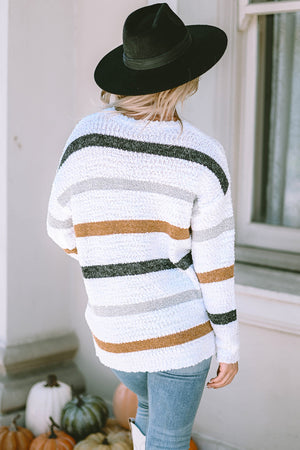 Textured stripe slouchy knit sweater in white with grey, black, and brown stripes.