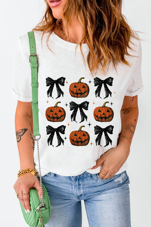 White graphic tee with a repeating pattern of jack-o'-lanterns and black bows.