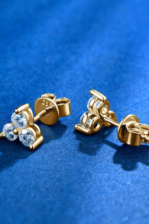 Gold Trilogy Moissanite Studs earrings with 925 sterling silver backing and clear stones.