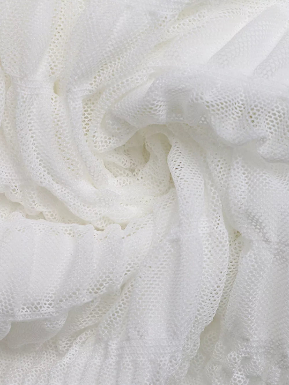 White textured smocked dress fabric with a deep v-neck detail
