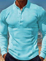 Pastel blue waffle knit long-sleeve polo shirt with button placket.