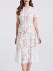 White lace midi dress with pearl embellishments and short sleeves.