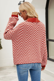 Chevron knit polo sweater in rust and white acrylic with a collared neckline and button detail.