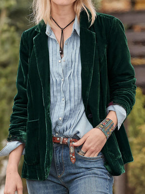 Dark green velvet blazer with rolled cuff detail and buttoned front.