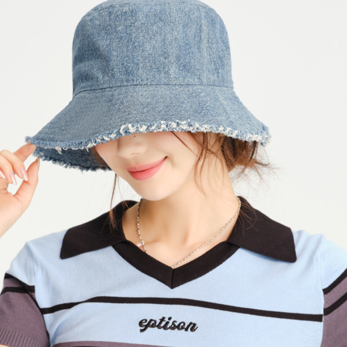 Light blue denim bucket hat with frayed hem detail