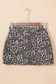Leopard print denim mini skirt with back pockets and frayed hem.