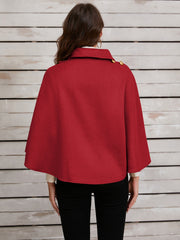 Deep Red asymmetric cape jacket with gold button detail and collar.