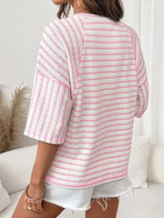 Pink and white wavy stripe knit t-shirt with relaxed fit and short sleeves.