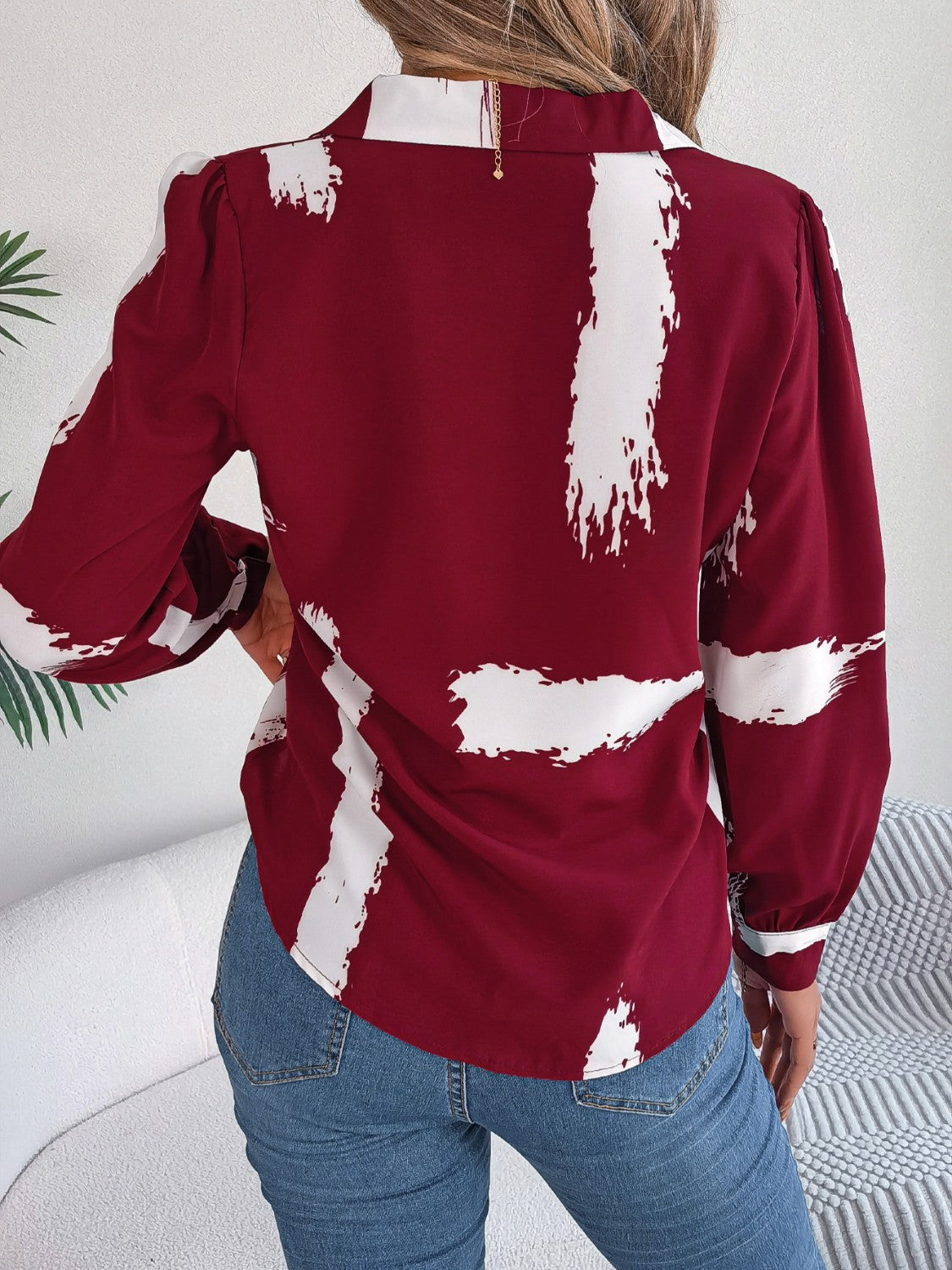 Burgundy brushstroke print collared blouse with puff sleeves and button cuffs.