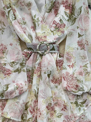 Floral ruffle hem wrap mini dress in light blue with long sleeves and a cinched waist belt.