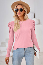 Blush pink textured crew neck top with puff sleeves and diamond pattern