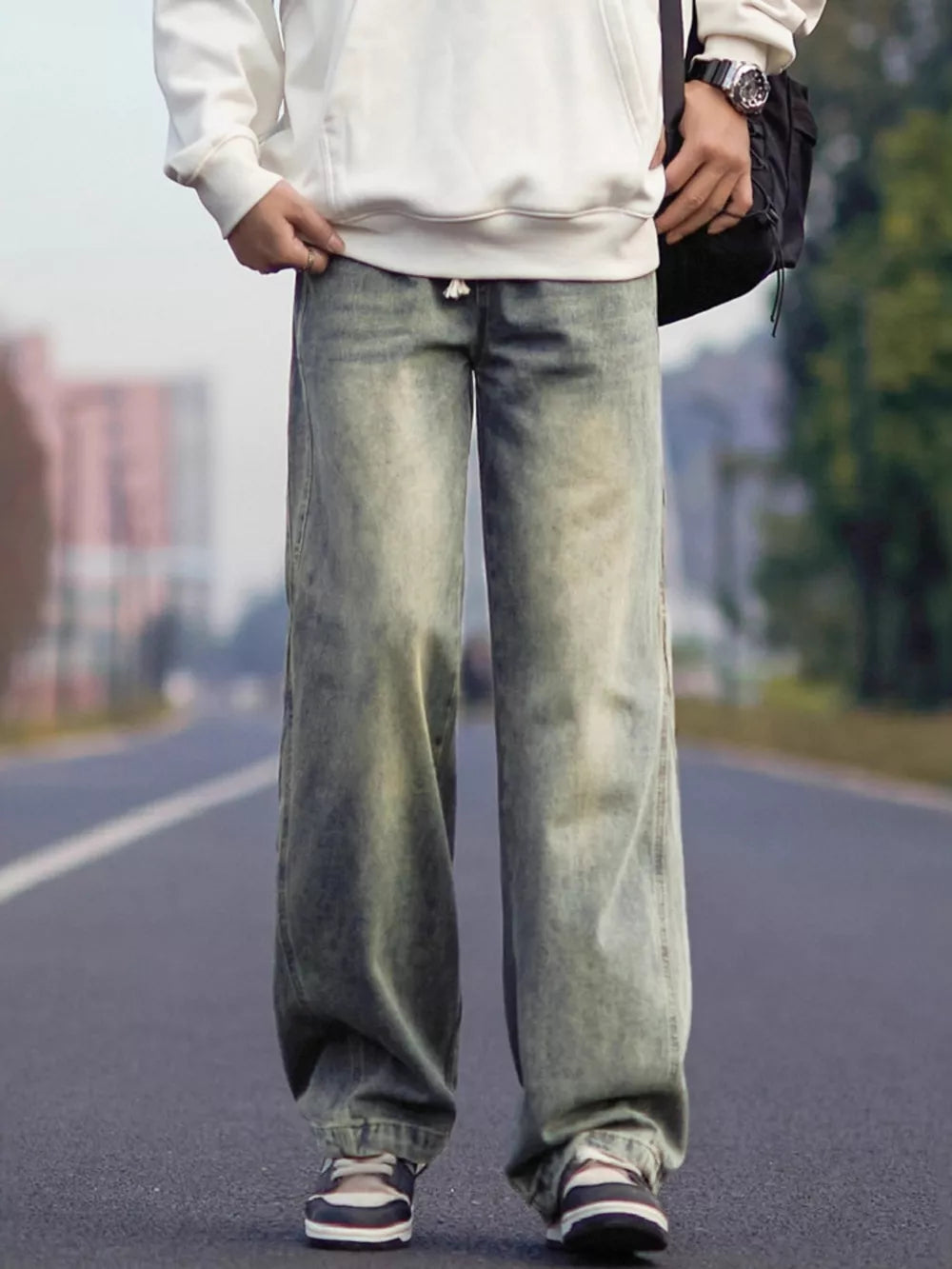 Relaxed fit jeans in a faded blue wash, made of 100 cotton with a drawstring waist.