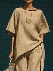 Khaki two-piece set with contrast trim, featuring a cropped pant and loose top.