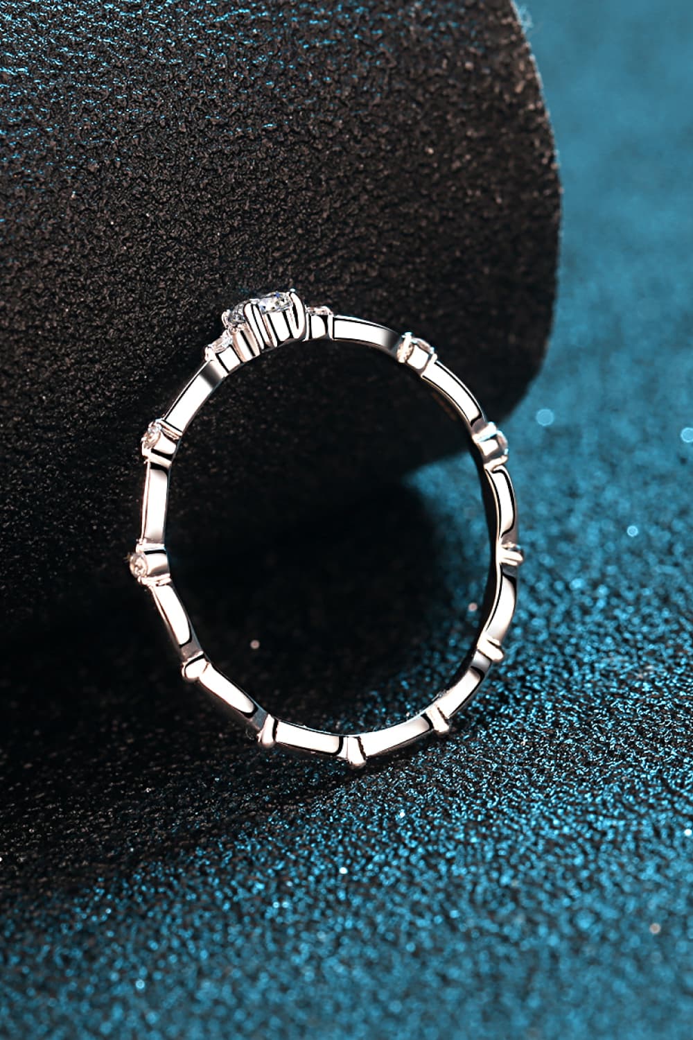 Delicate silver band ring with scalloped edges and small diamonds