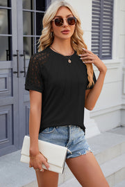 Black ribbed tee with lace raglan sleeves and pintuck detail.