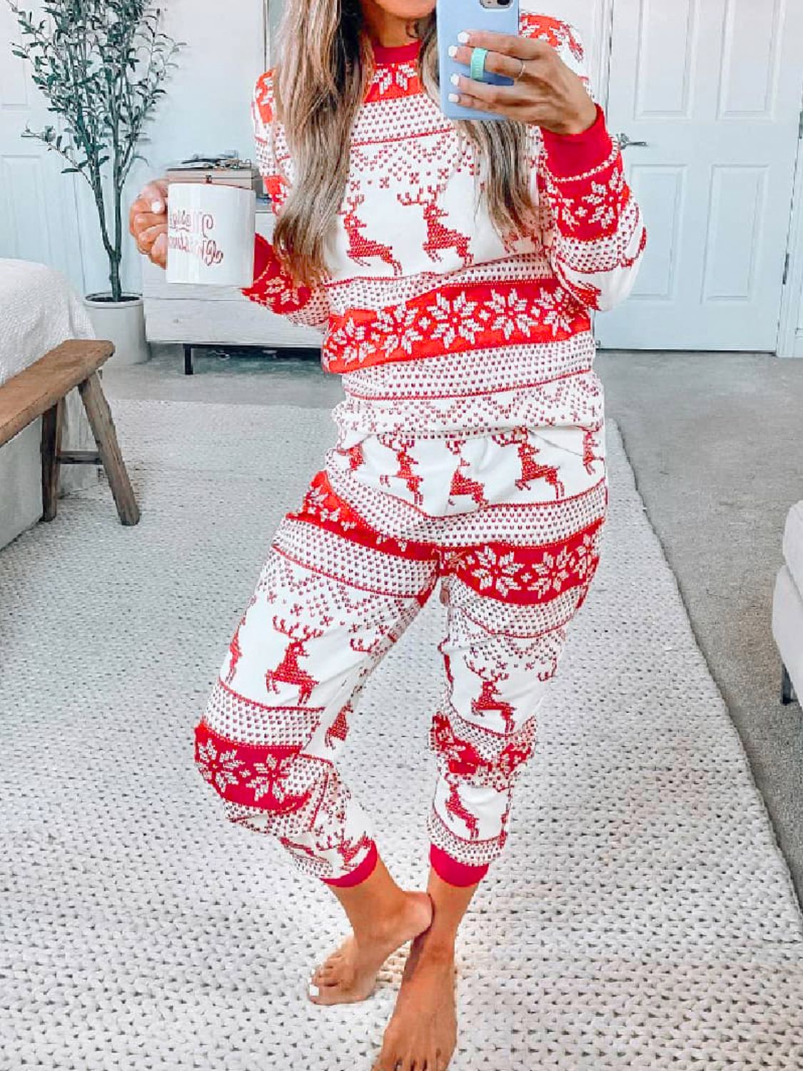 Festive reindeer knit lounge set in orange-red with snowflake pattern, crew neck, long sleeves, and jogger pants.