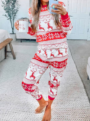 Festive reindeer knit lounge set in orange-red with snowflake pattern, crew neck, long sleeves, and jogger pants.