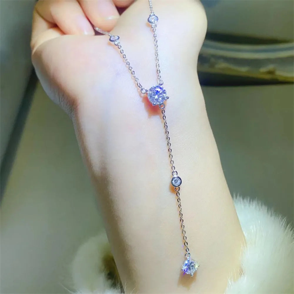 Silver lariat necklace with a dazzling drop detail featuring multiple moissanite stones.