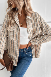 Textured tweed shirt jacket in tan with buttoned pockets and pearl buttons.