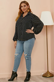 Black polka dot blouse with shirred balloon sleeves and a collared neckline.
