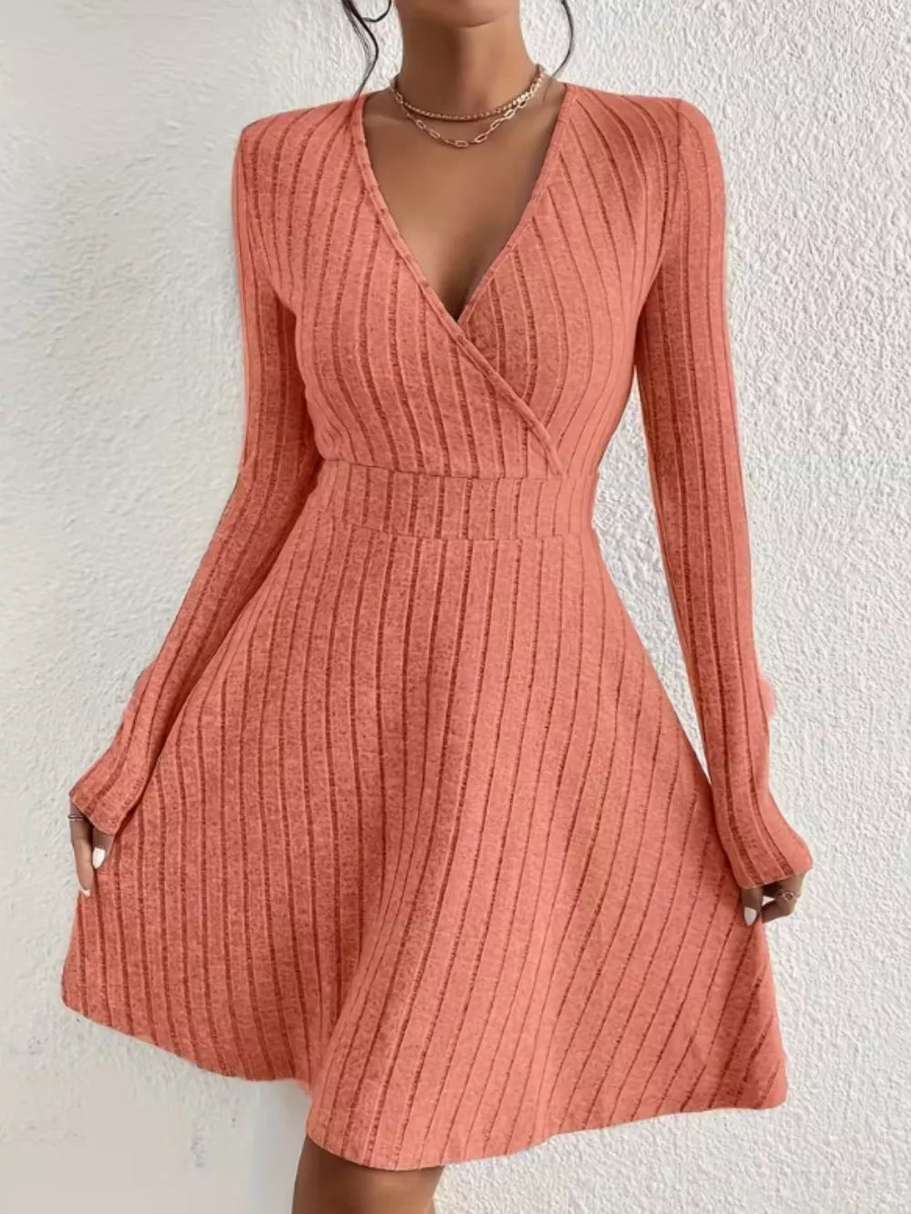 Burnt Coral ribbed wrap mini dress with long sleeves and a V-neck.