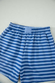 Relaxed blue striped cotton shorts with elastic waistband and patch detail.