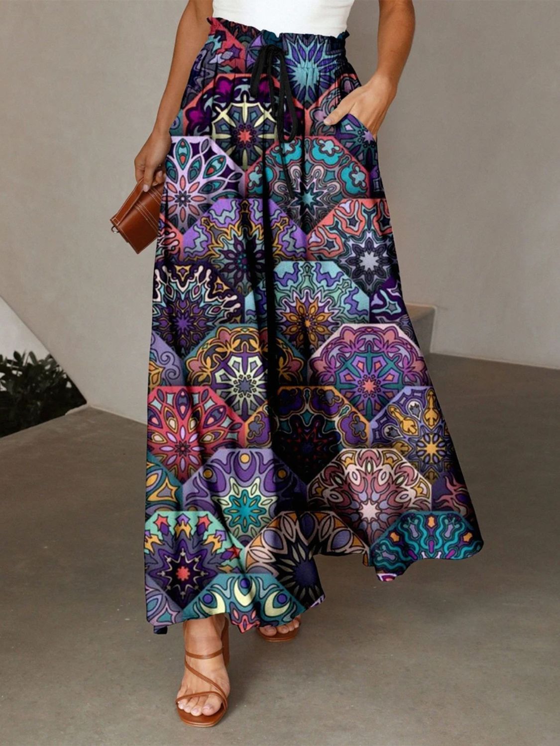 Maxi skirt with multicolor geometric print, adjustable drawstring waist, and pockets.