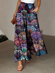 Maxi skirt with multicolor geometric print, adjustable drawstring waist, and pockets.
