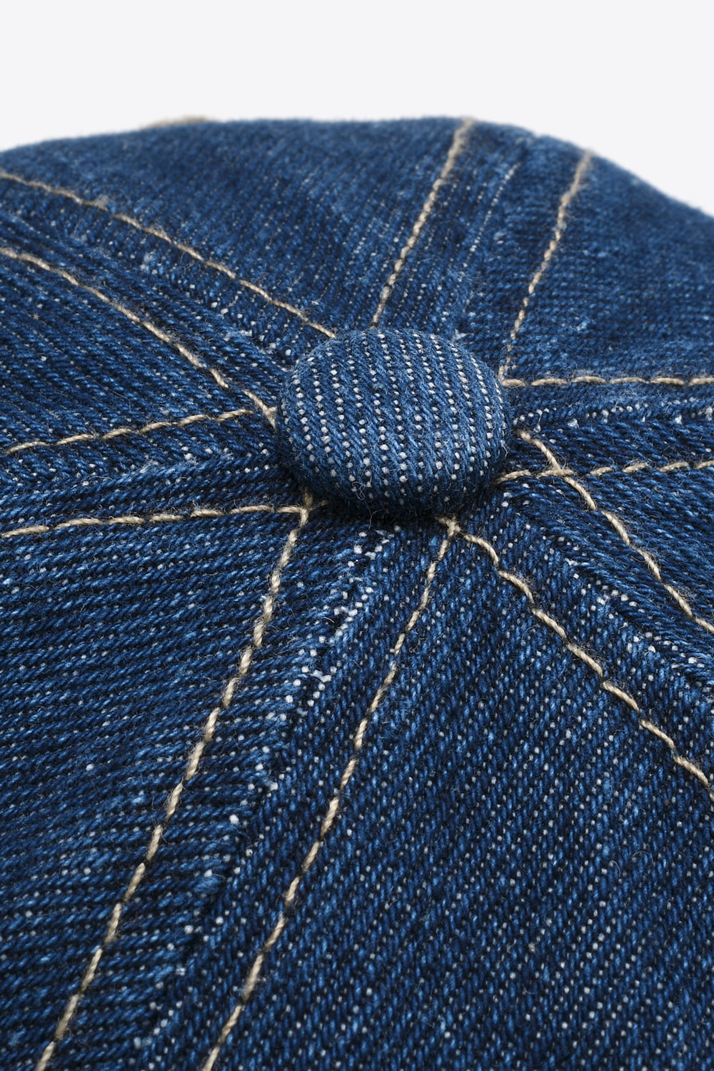 Denim baseball cap in dark blue with contrast stitching and button detail.