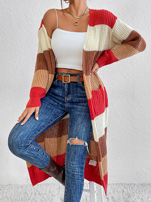 Striped knit maxi cardigan in red, orange, brown, and cream with pockets.