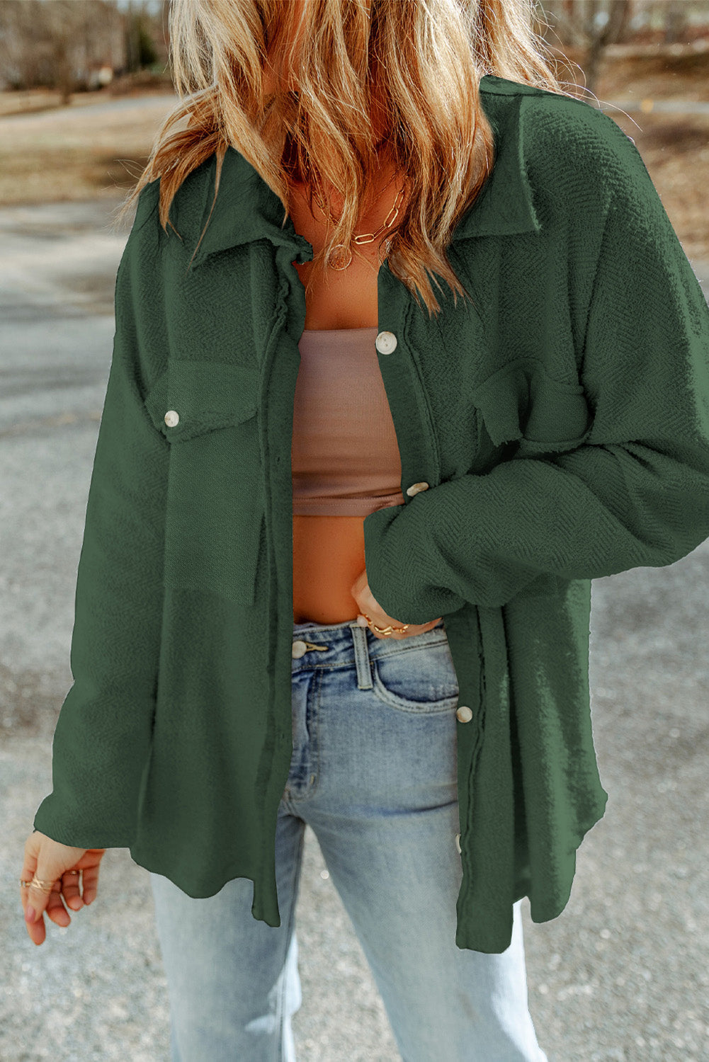 Dark green textured shacket with raw edges and button details.