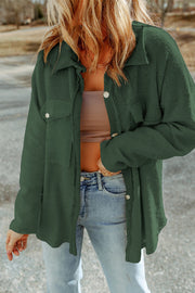 Dark green textured shacket with raw edges and button details.