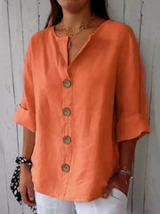 Orange button-down shirt with relaxed fit, cuffed sleeves, and wooden buttons.